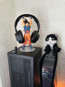 Black fluffy cat toy and Dragon Ball Super Super Saiyan Goku