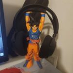 Goku Stand holding steelseries headphones