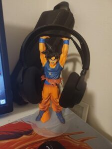 Goku Stand holding steelseries headphones