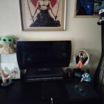 A computer desk with a Goku earphone stand