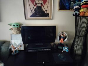 A computer desk with a Goku earphone stand